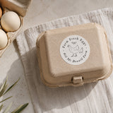 Egg carton with a cardboard box and a label that is stamped with 'Farm Fresh Eggs'. 