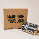 Large custom rubber stamp with a stamped logo impression on a kraft paper box