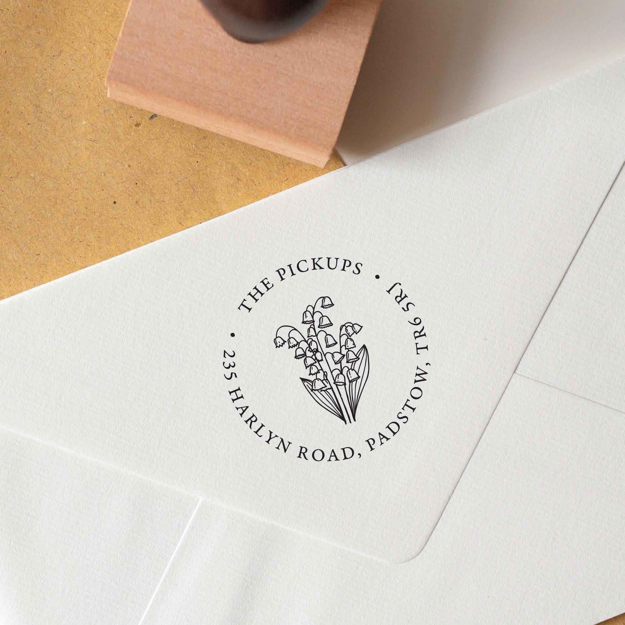 Personalised Birth Flower Address Stamp with flowers in the centre and address details in a circular layout around the flowers stamped onto an envelope 