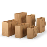 Set of brown paper bags of different sizes on a white background