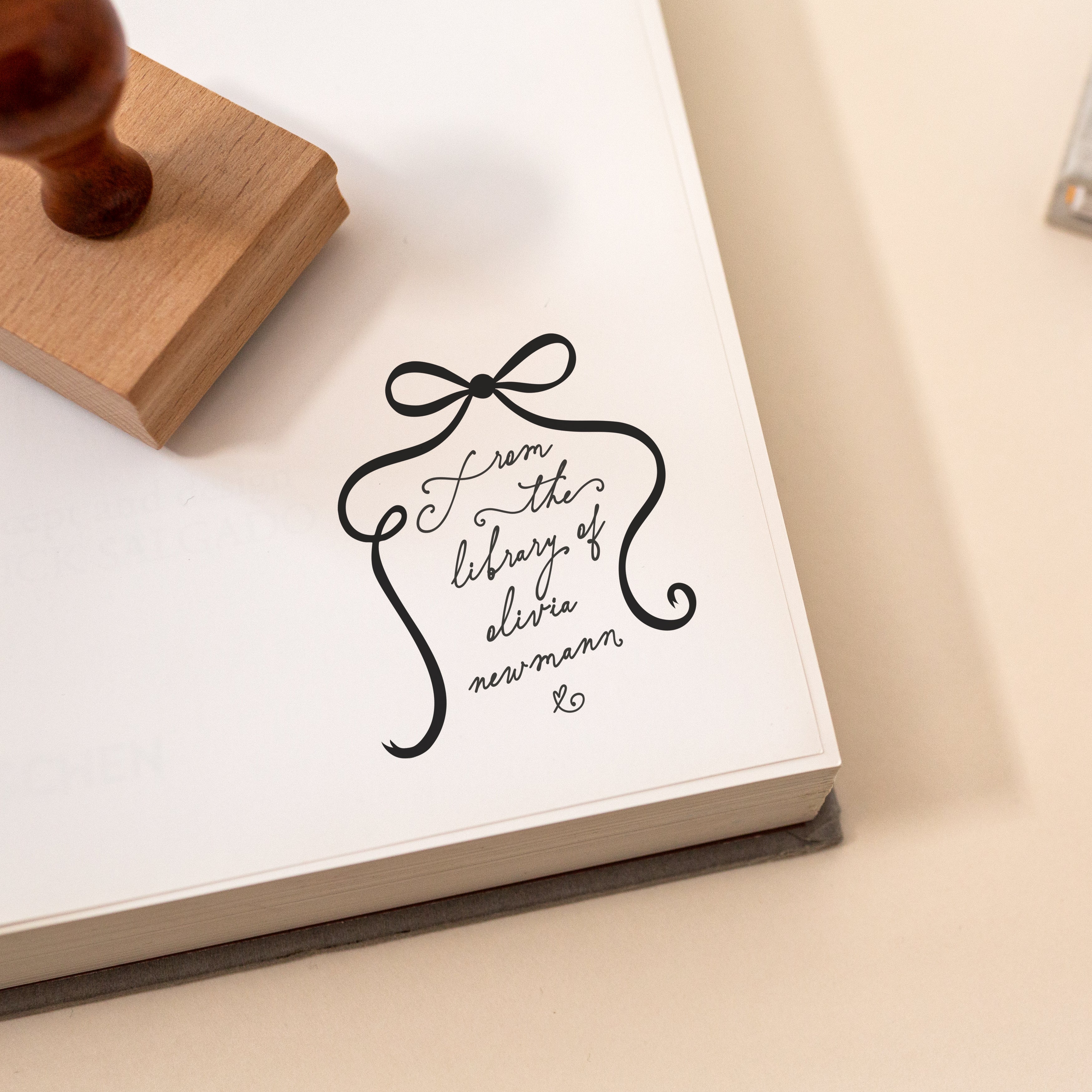 Personalised from the library of rubber stamp with bow frame and handwritten script on book page