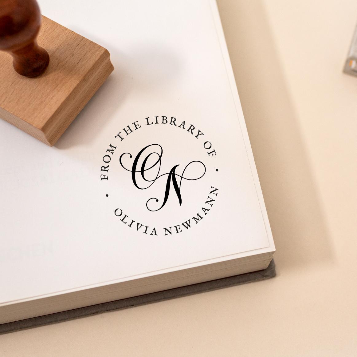 Book with a personalised stamp reading 'From the Library of' and an elegant customised monogram design.