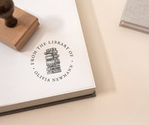 Personalised from the library of stamp with stacked books illustration and the wording 'from the library of' and your name.