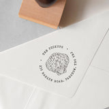 custom beach address stamp featuring a seashell design and a personalised address stamped onto an envelope