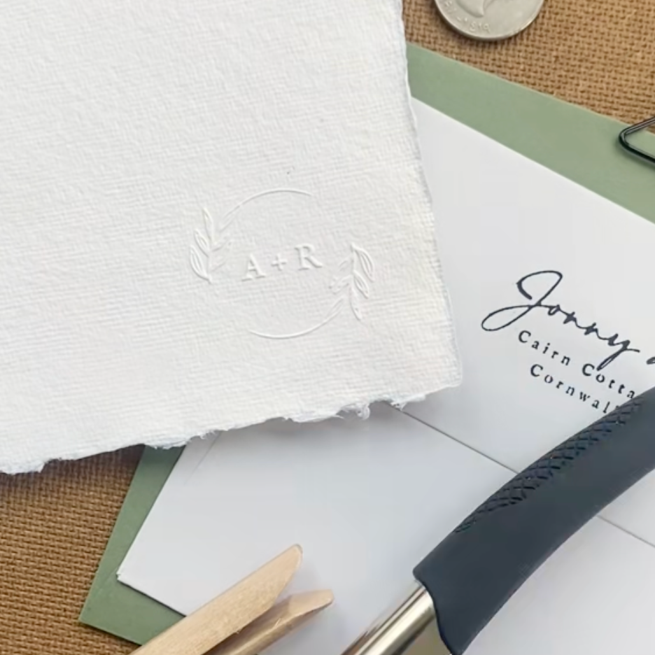 Botanical Wedding Embosser with couples initials and floral illustration in a circular design around the initials