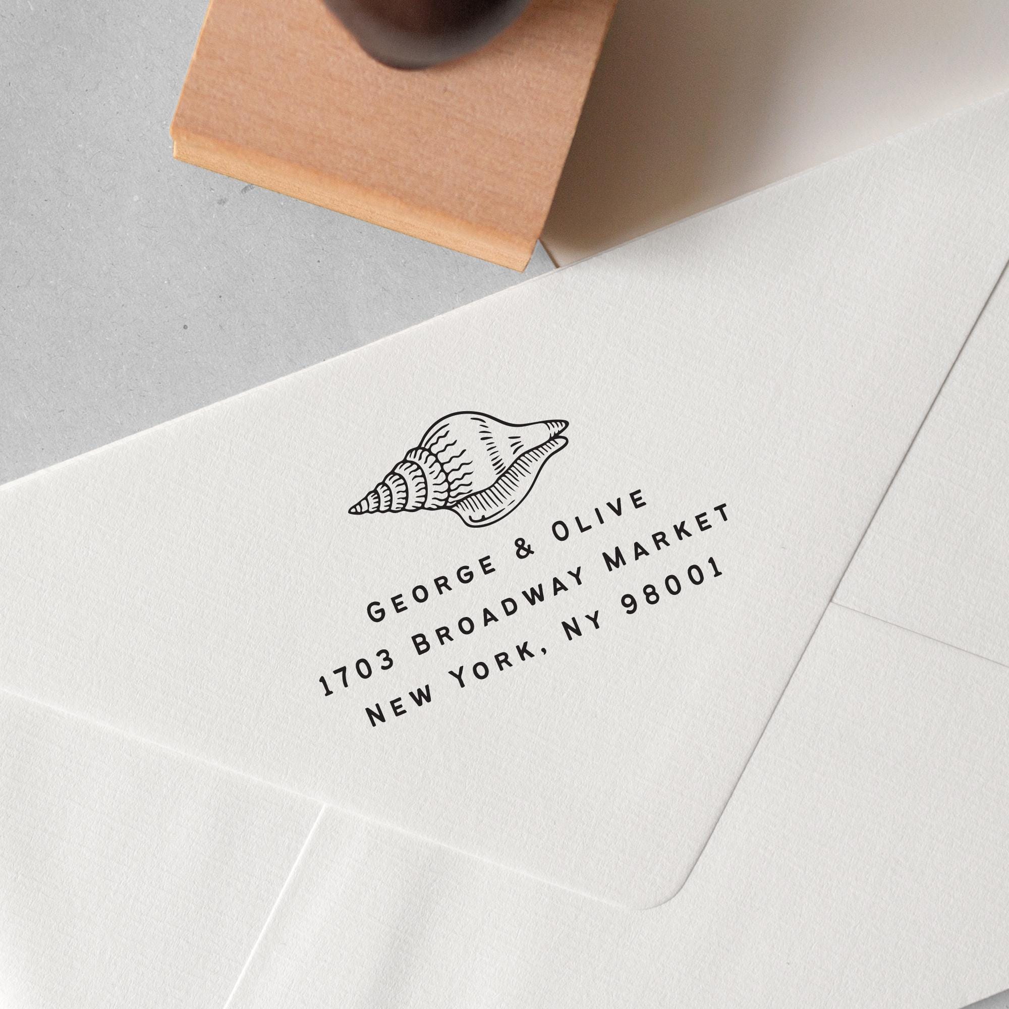 custom beach address stamp featuring a seashell design, personalised address details stamped on to an envelope