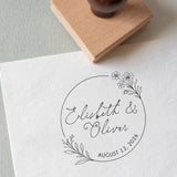 Personalized wedding stamp with names and date, and a beautiful floral wreath stamped onto a wedding card