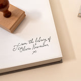Personalised from the library of stamp with handwritten script name on book page