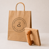 Large custom rubber logo stamp with stamped paper bag reading "Made from Your Logo"