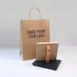 Kraft paper bag with 'MADE FROM YOUR LOGO' text and a large custom rubber stamp on a white background