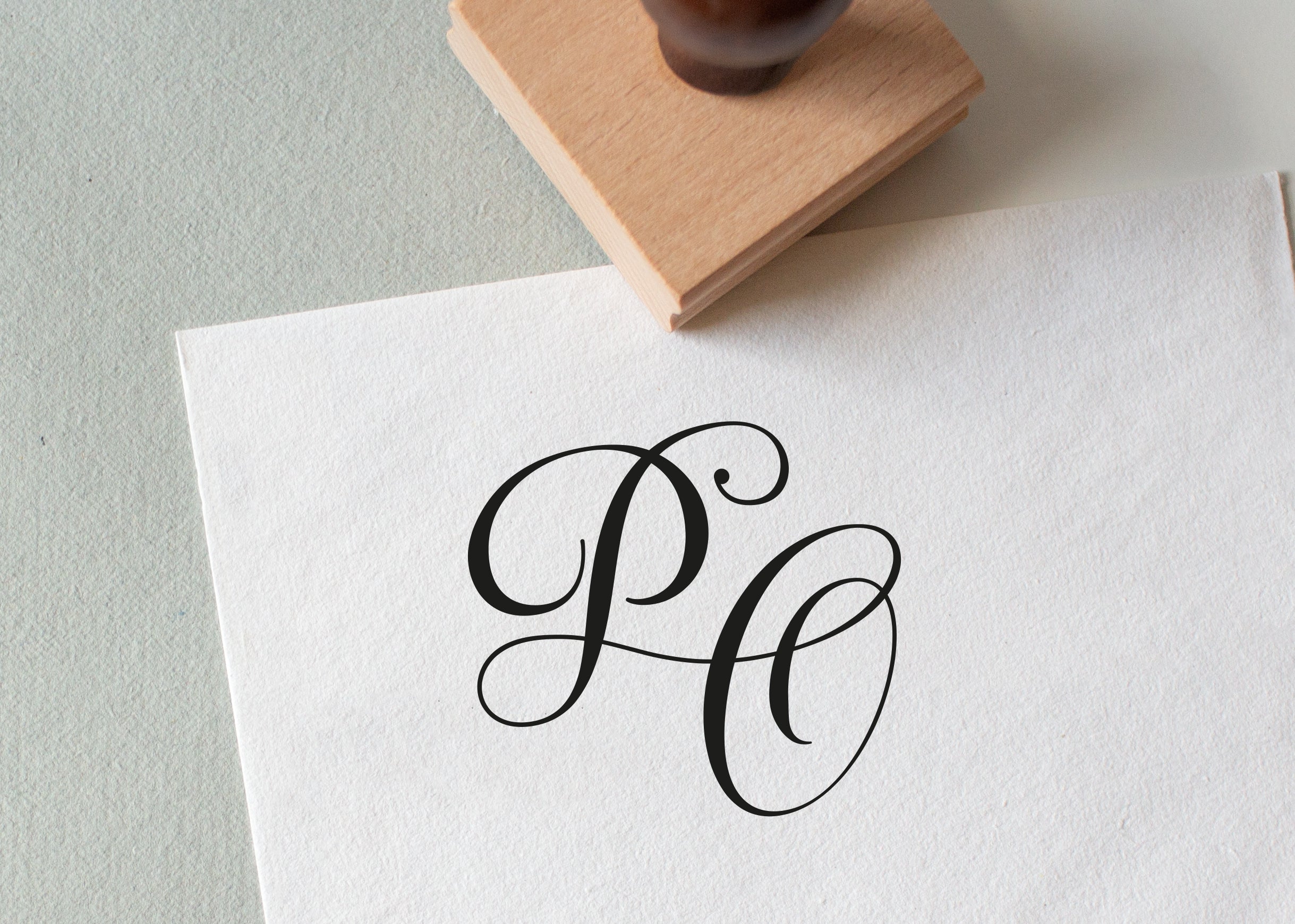 rubber stamp that stamped the initials PO onto a piece of paper, perfect for wedding stationery 