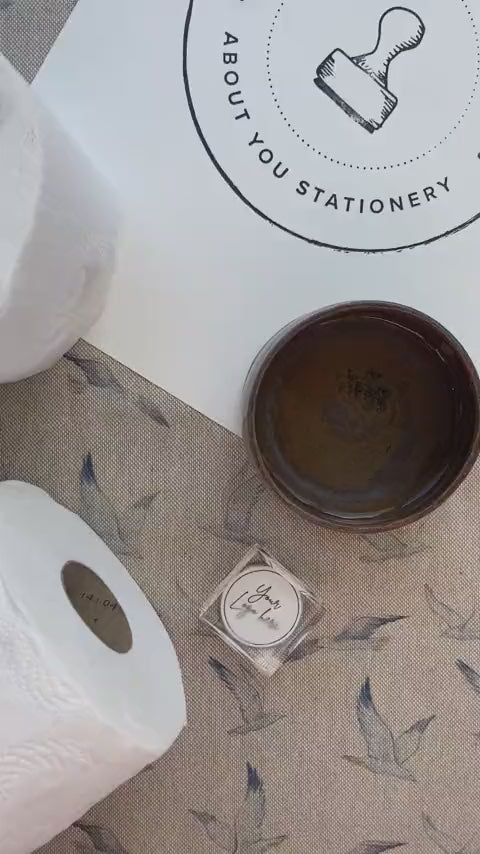 Video of a toilet roll stamp or pixie stamp being used on a toilet roll and leaving a raised logo impression in to the toilet roll 