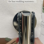 a video of the best kept secret for luxe wedding stationery: a custom wedding botanical initials embosser