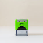 Video featuring an eco-friendly, green,  self-inking logo stamp stamping a logo with the wording 'your logo here' onto brown kraft paper