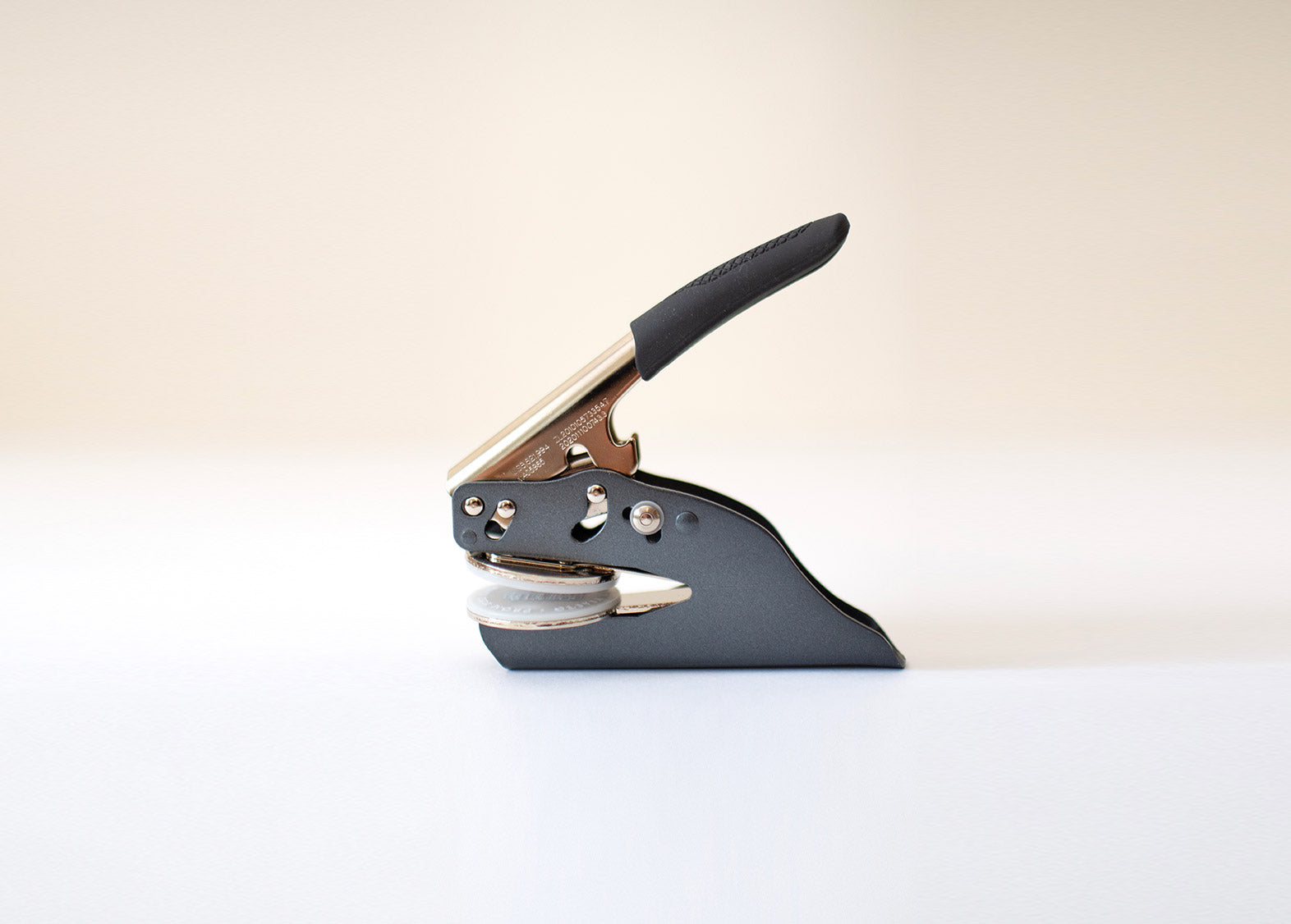 Black and silver, steel embosser on a white background