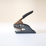 Black and silver, steel embosser on a white background