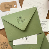 Calligraphy Monogram design stamped on a textured green envelope 