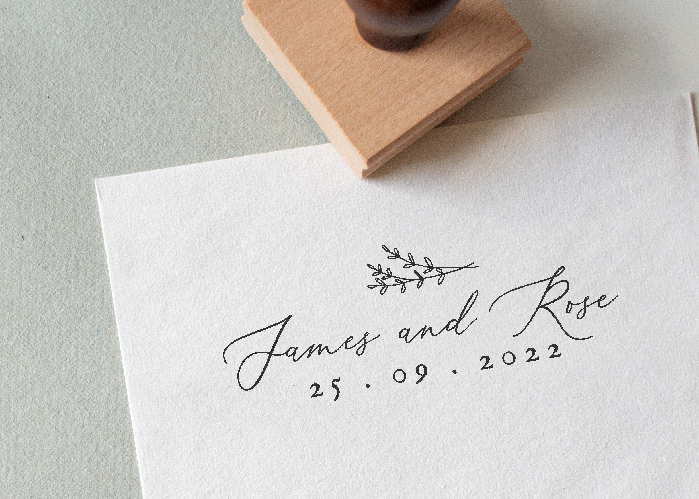 Elegant Wedding Stamp with Names and Date and a botanical illustration stamped on white textured paper paper