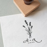 Lavender wedding stamp with couple’s initials and date, stamped on white textured paper