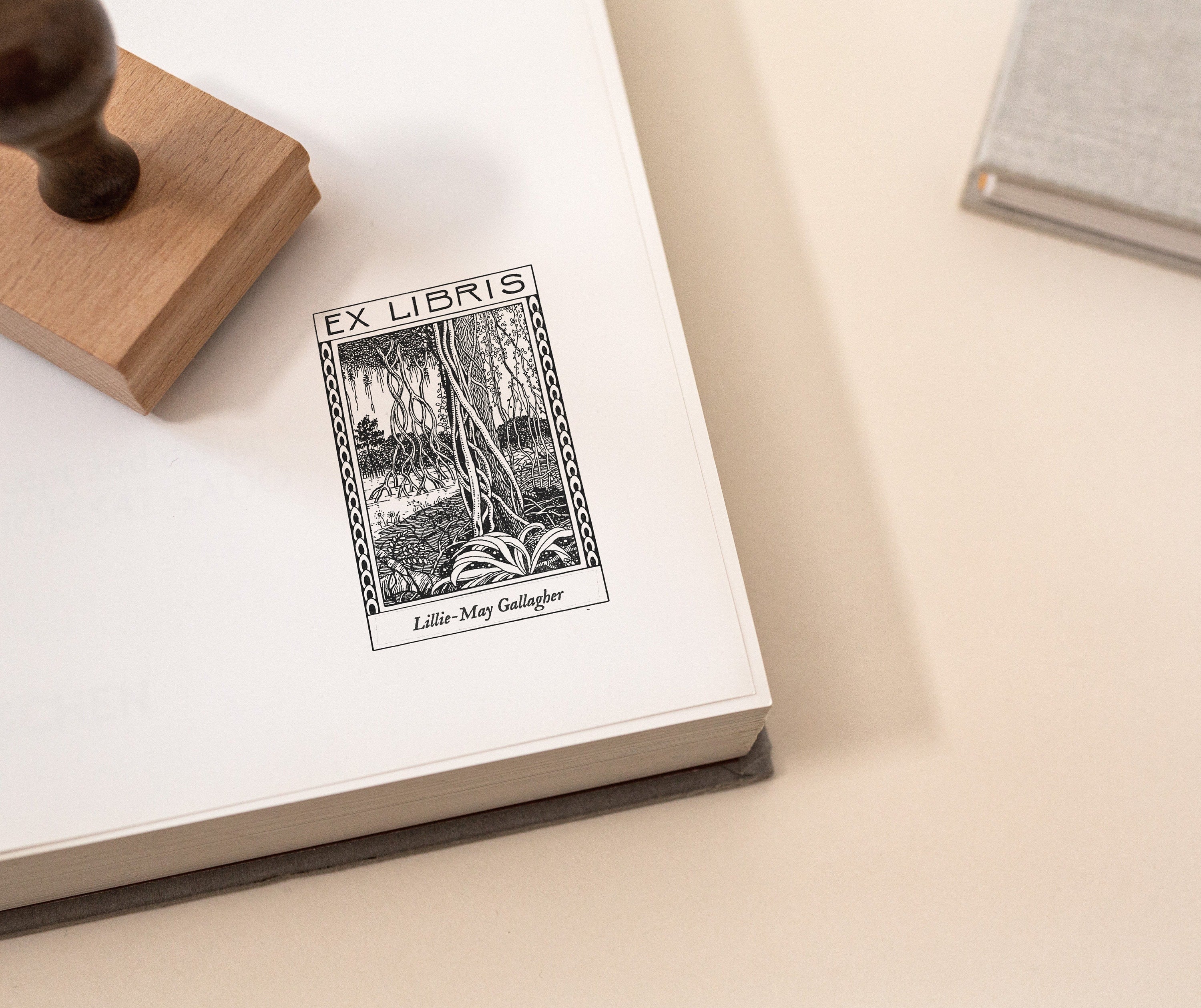 Personalised ex libris stamp with vintage forest illustration on book page