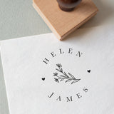 Daisy's wedding stamp with the couple’s names in a circular layout, stamped on white textured paper