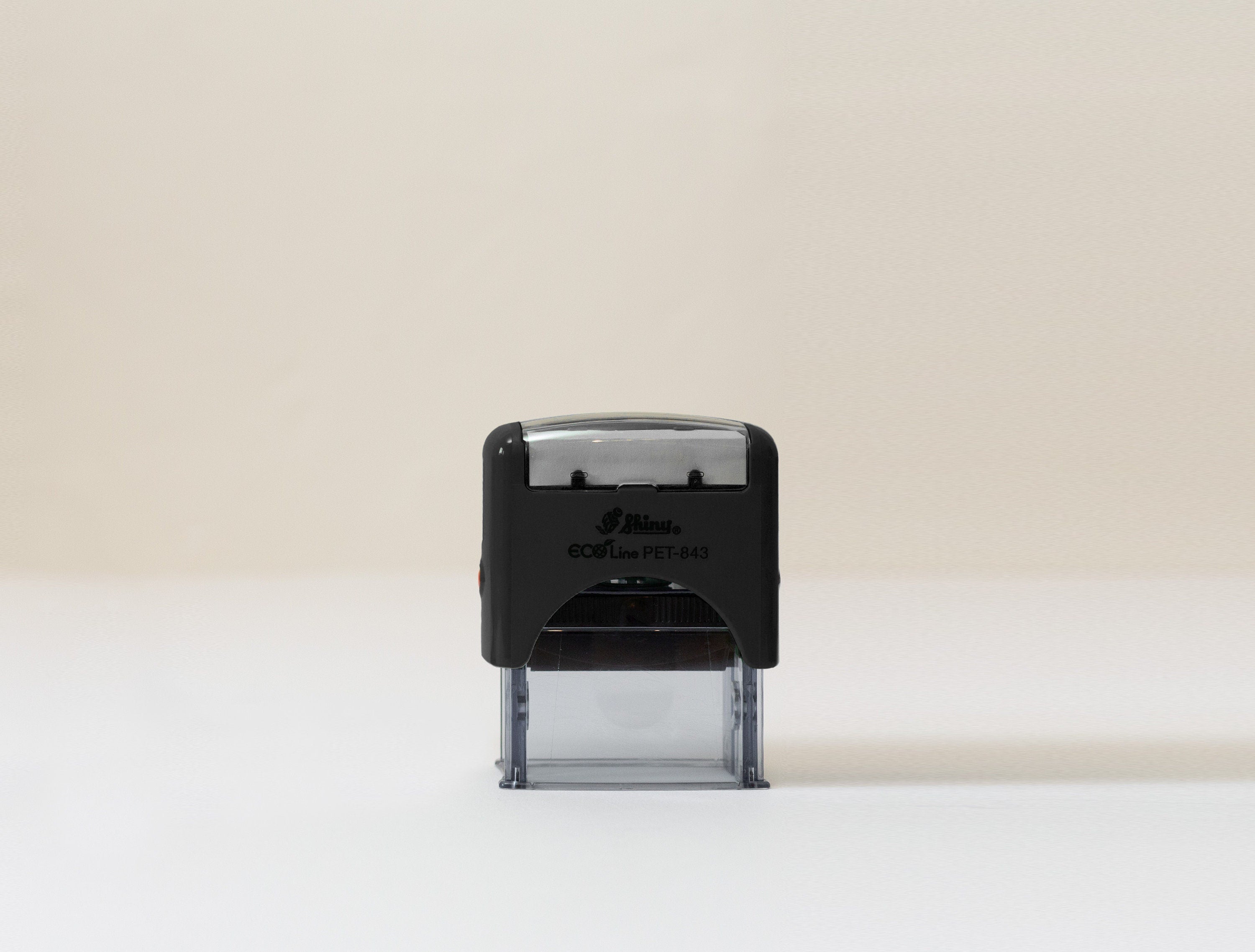 Self-inking logo stamp with custom logo, available in round or rectangular shapes for easy and professional business branding.